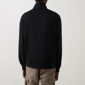 Model wearing Hugo Logo Half-Zip Sweatshirt in black, rear view, styled with beige cargo trousers