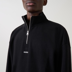 Model wearing Hugo Logo Half-Zip Sweatshirt in black, with silver half-zip fastening and embroidered logo at chest