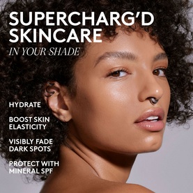 Model with glowing, even skin tone promoting FENTY Hydra Vizor Huez Tinted Moisturizer Mineral SPF 30, shown in a campaign image