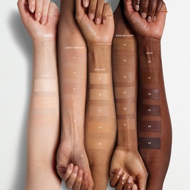 FENTY Eaze Drop Blurring Skin Tint foundation shades swatched across five arms in a range of skin tones, from fair to deep