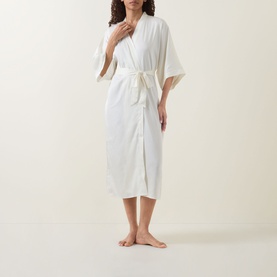 Model wearing Gingerlilly Henrietta Satin Robe in ivory, wrap style with shawl collar, wide mid-length sleeves and self-fabric belt tie