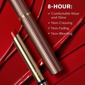Est&eacute;e Lauder Pure Colour Explicit Slick Shine Lipstick in red, gold-toned bullet and cap, shown with 8-hour wear claims on red background
