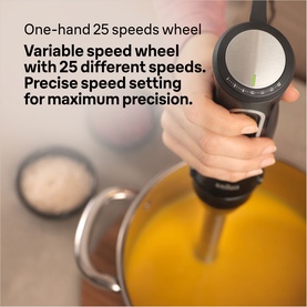 Braun Multiquick 5 Stick Blender in black, one-hand 25-speed wheel shown in use blending orange soup in a large pot.