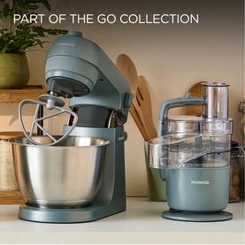 Kenwood Quickmix Go 5 Speed Hand Mixer in grey, styled alongside a matching grey stand mixer and food processor on a kitchen counter.