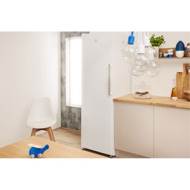 Indesit Freestanding 60cm NoFrost Freezer 223L in white, shown in a modern kitchen lifestyle setting with wooden worktop