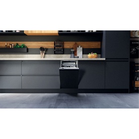 Hotpoint Built-In Slimline Dishwasher 9 Place 54cm installed in a modern black kitchen with wood shelving and utensils