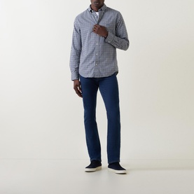 Model wearing Gant Embroidered Logo Gingham Shirt in navy, button-down collar, styled with dark blue jeans and navy trainers
