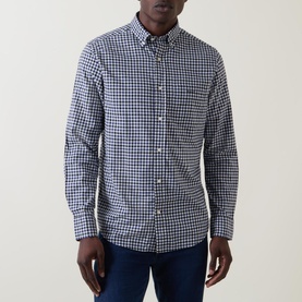 Model wearing Gant Embroidered Logo Gingham Shirt in navy, button-down collar, long sleeves, chest patch pocket, styled with dark jeans