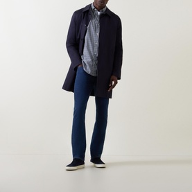 Model wearing Gant Navy Embroidered Logo Gingham Shirt, styled with a navy overcoat, blue jeans and navy canvas shoes