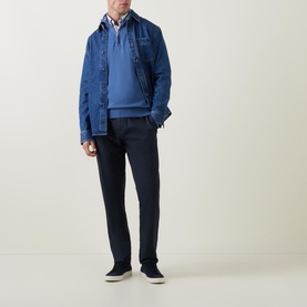 Model wearing Gant Shield Half-Zip Logo Sweater in blue, styled with a denim jacket, white shirt, and navy trousers