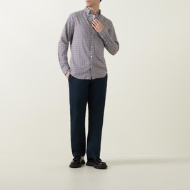 Model wearing Gant Checked Light Twill Regular Shirt in small check pattern, styled with navy trousers and black loafers
