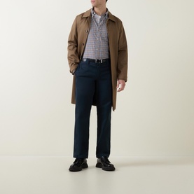 Model wearing Gant Checked Light Twill Regular Shirt in small check, styled with tan overcoat, navy trousers, and black loafers
