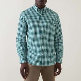 Model wearing Gant Gingham Single-Cuff Casual Shirt in green, featuring button-down collar, chest pocket, and long sleeves. Styled with beige chinos