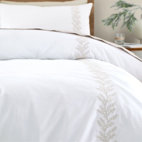 Bianca Embroidery Leaf Duvet Set in white with natural tonal leaf embroidery border, styled on a bed with matching pillowcase