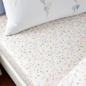 Bianca Brushed Balloon Fitted Sheet White on a children's bed, featuring a pastel multicolour polka dot pattern with balloon-print pillowcase