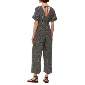 Model wearing Whistles Printed Jumpsuit in black and white geometric stripe, showing low back tie detail, wide-leg crop and black sandals