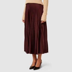 Model wearing Forever New Estelle High-Rise Pleated Skirt in burgundy, midi length with satin pleats, styled with black slingback heels
