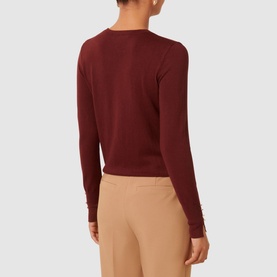 Model wearing Forever New Katie Split-Cuff Sweater in burgundy, showing back view with long sleeves, split cuffs, and crew neckline