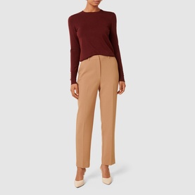 Model wearing Forever New Katie Split-Cuff Sweater in dark red with camel straight-leg trousers and cream heels
