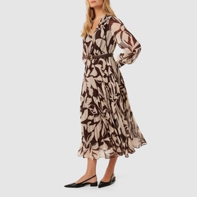 Model wearing Forever New Saskia Printed Pleated Dress in multi, floral print midi length, styled with black pointed-toe flats