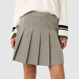 Model wearing Forever New Montana Pleated Mini Skirt in grey check with pleated detail, styled with a white varsity-stripe jumper