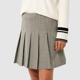 Model wearing Forever New Montana Pleated Mini Skirt in grey check with pleated detailing, styled with a white varsity-stripe sweater