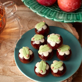 Fortnum & Mason Marzipan Christmas Puddings 100g, miniature chocolate fondant cakes topped with white and green marzipan holly decoration on teal