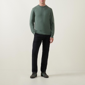 Model wearing Hugo Boss Orange Black Slim-Leg Chinos, styled with a green crew-neck sweatshirt and grey trainers
