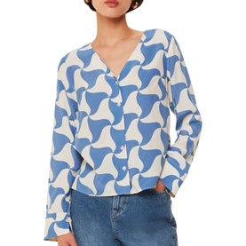 Model wearing Whistles Triangle Swirl Blouse in blue with white geometric swirl print, V-neckline, long blouson sleeves, styled with blue jeans