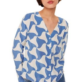 Model wearing Whistles Triangle Swirl Blouse in blue and white geometric print, V-neckline, long blouson sleeves with button fastening