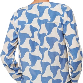 Model wearing Whistles Triangle Swirl Blouse in blue and cream geometric print, long blouson sleeves with single-button cuffs, rear view