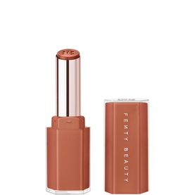 Fenty Gloss Bomb Stix High Shine Gloss Stick in Fenty Glow, nude-peach bullet with rose gold casing, cap removed, 3.6g