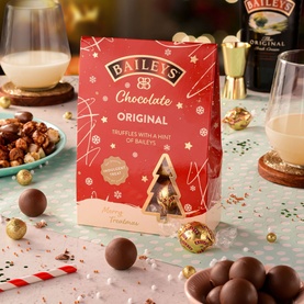 Baileys Christmas Tree Truffle Carton 146g, red festive packaging with chocolate truffles scattered around