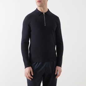 Model wearing Samsoe & Samsoe Guna Half-Zip Sweater in navy, featuring flat-knit collar and silver half-zip placket, styled with navy trousers