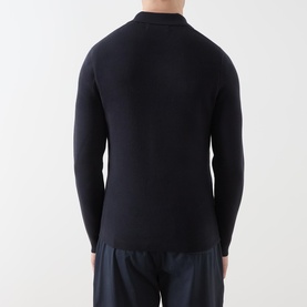 Model wearing Samsoe & Samsoe Guna Half-Zip Sweater in navy, shown from behind, styled with navy trousers
