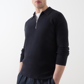 Model wearing Samsoe & Samsoe Guna Half-Zip Sweater in navy, with flat-knit collar and silver zip, styled with dark trousers