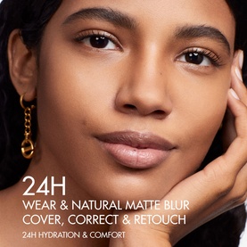 Model wearing Dior Forever Skin Perfect Foundation Stick, showcasing 24H natural matte blur finish on medium-deep complexion, with gold hoop earring