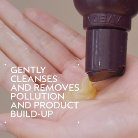 AVEDA Invati Ultra Advanced&trade; Exfoliating Shampoo Light being dispensed onto a palm, demonstrating lightweight gel texture
