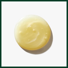 AVEDA Invati Ultra Advanced Exfoliating Shampoo Light, pale yellow creamy texture shown as a scooped disc on white background