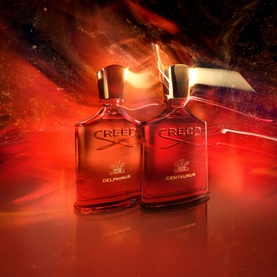 CREED Centaurus Eau de Parfum 100ml, red bottle with gold cap, styled alongside Delphinus EDP against dramatic red backdrop
