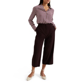 Model wearing Phase Eight Gina Printed Shirt in multi geometric print, styled with dark wide-leg culottes and cream flat shoes