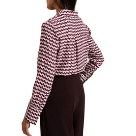 Model wearing Phase Eight Gina Printed Shirt in multi geometric print, styled with dark burgundy wide-leg trousers. Back view shown