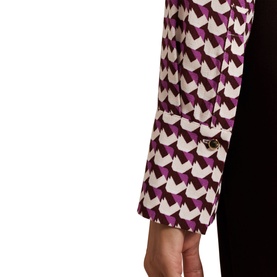 Model wearing Phase Eight Gina Printed Shirt in purple and cream geometric print, showing long sleeve with buttoned cuff detail