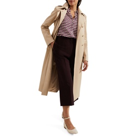 Model wearing Phase Eight Gina Printed Shirt in multi geometric print, styled with beige trench coat, dark cropped trousers and white heels