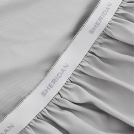 Sheridan 1000 Thread Count Fitted Sheet in light grey cotton sateen, close-up showing elasticated branded waistband and gathered fabric detail
