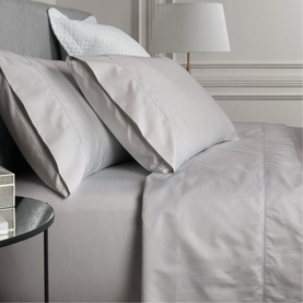 Sheridan 1000 Thread Count Fitted Sheet in Dove light grey cotton sateen, styled on a bed with matching pillowcases