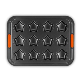 Le Creuset 12-Cup Non-Stick Bakeware Star Tray 40cm in dark grey with orange silicone handles, overhead view showing 12 star-shaped cups