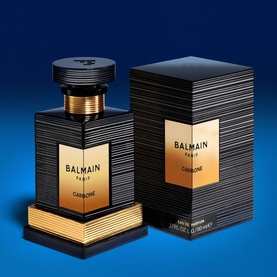 Balmain Carbone Eau de Parfum in black and gold ribbed bottle with matching gift box on blue background