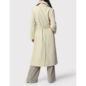 Model wearing Helen McAlinden Hazel Wrap Coat in cream wool blend, self-fabric belt, rear slit visible, styled with grey wide-leg trousers