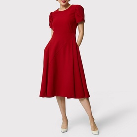 Model wearing Helen McAlinden Vera Fit-And-Flare Dress in red, midi length with puffed sleeves and flared skirt, styled with cream heels